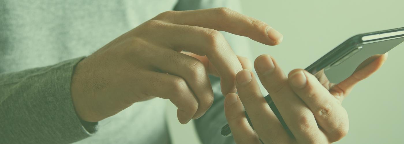 Close up image of person using a mobile phone.